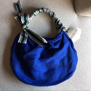 Blue hobo tote bag with ribbon wrapped strap